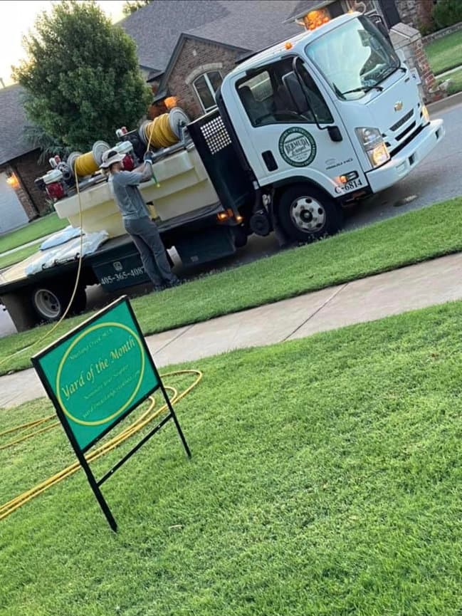 Bermuda Escapes treatment truck at a Yard of the Month lawn